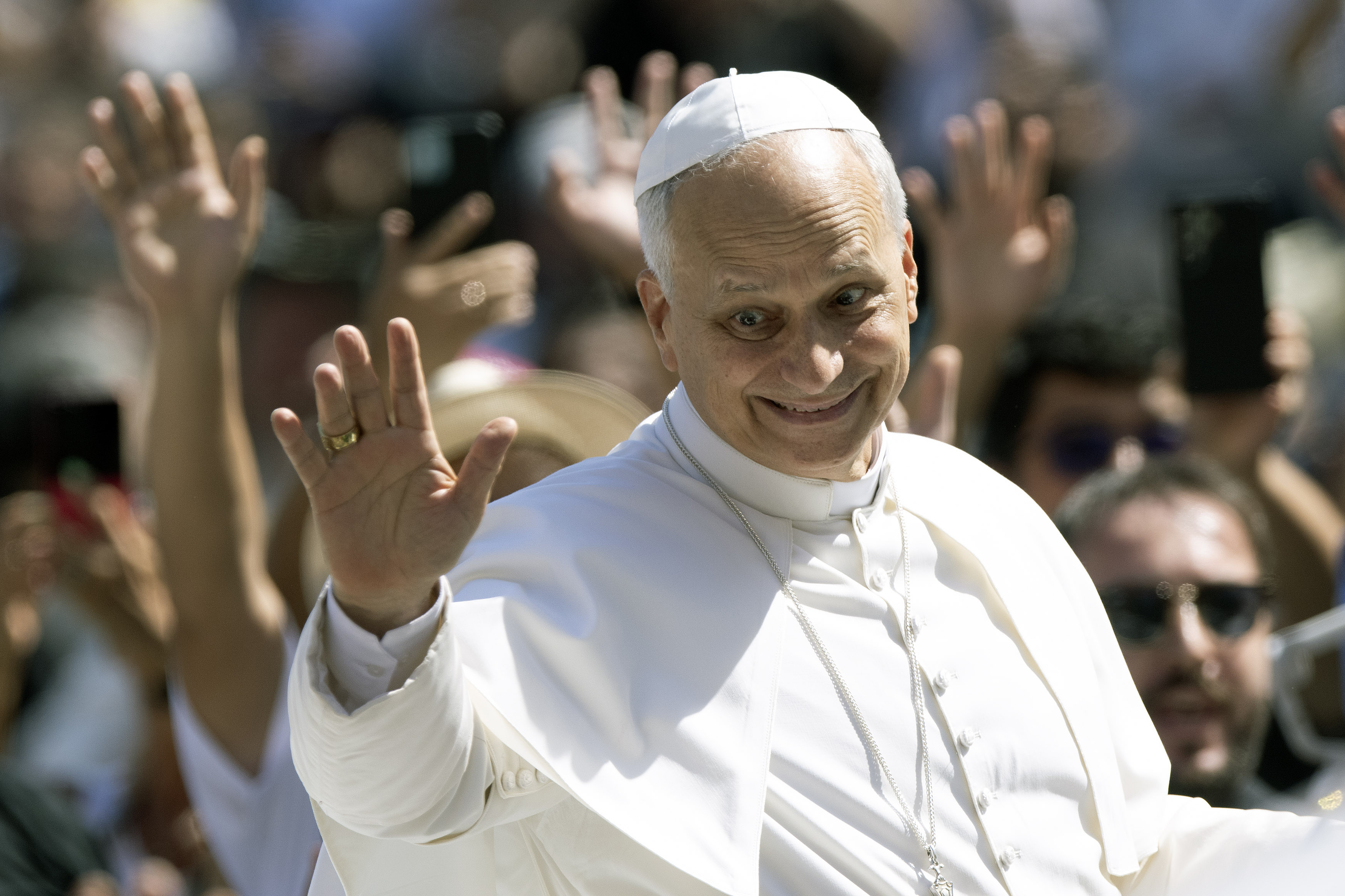 Pope Leo XIV waving to a crowd in St. Peter's Square.