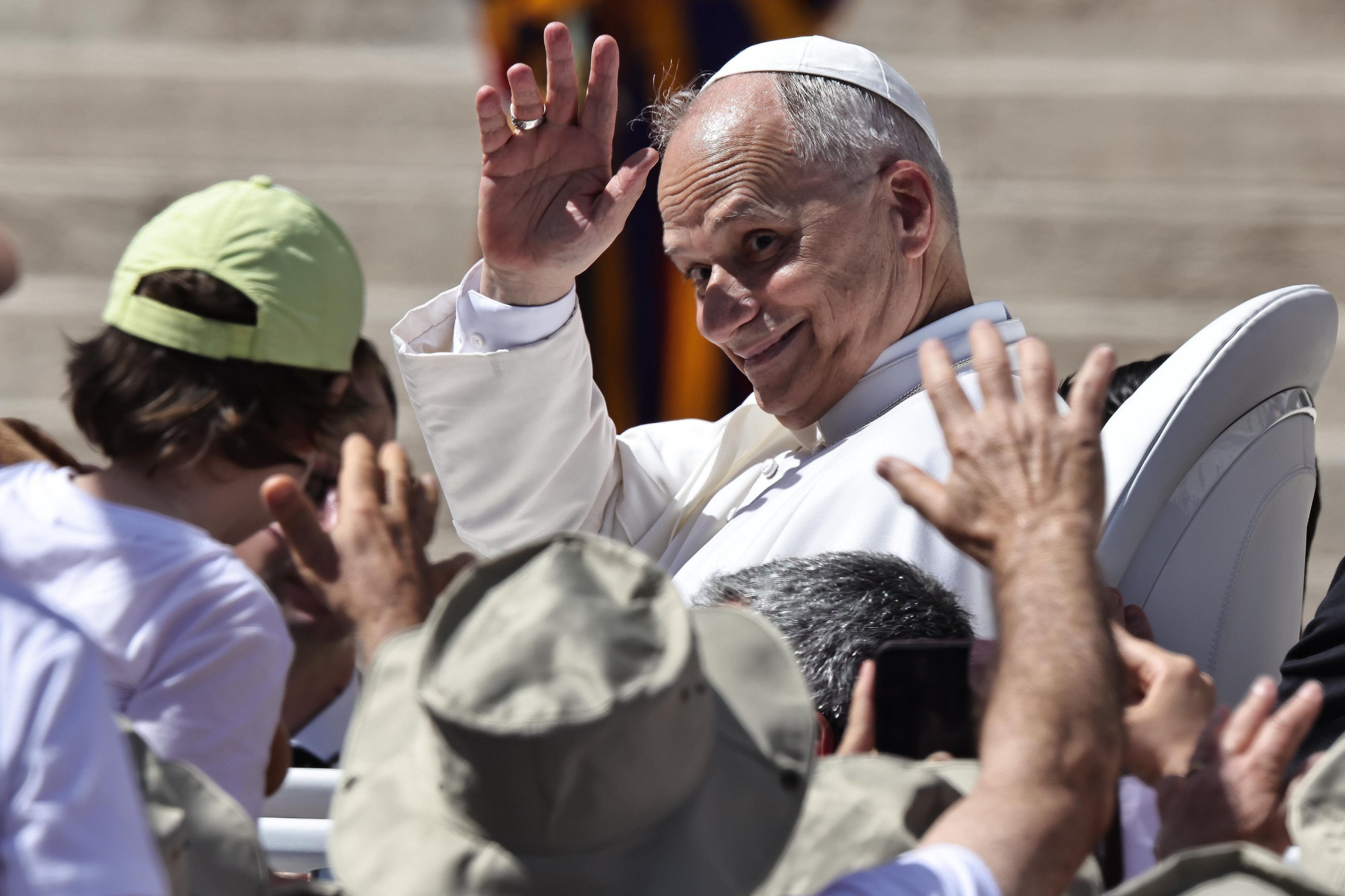 Pope Leo XIV waving to the crowd during a general audience.