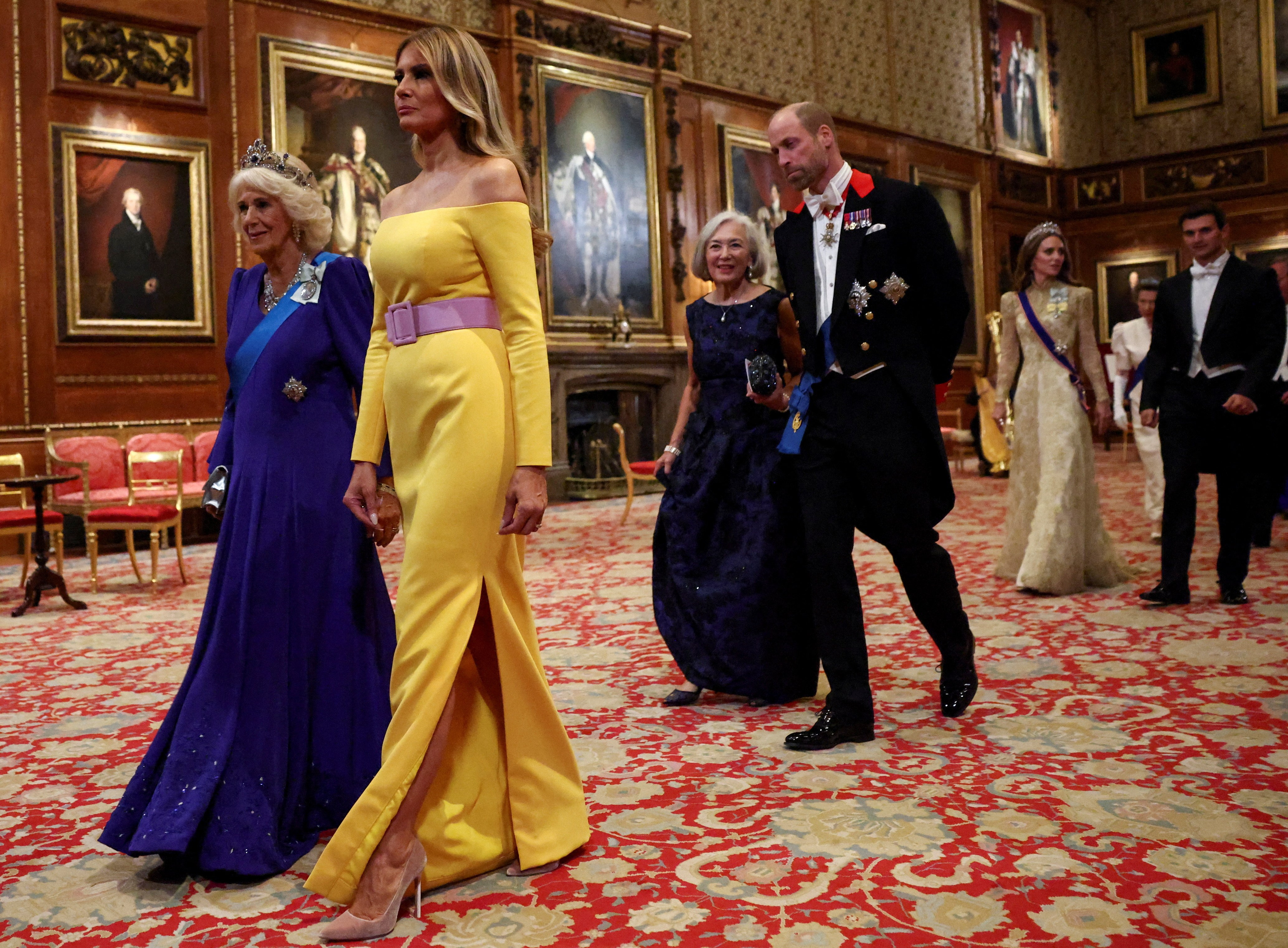 Melania Trump, Queen Camilla, and Prince William walking at a state banquet.