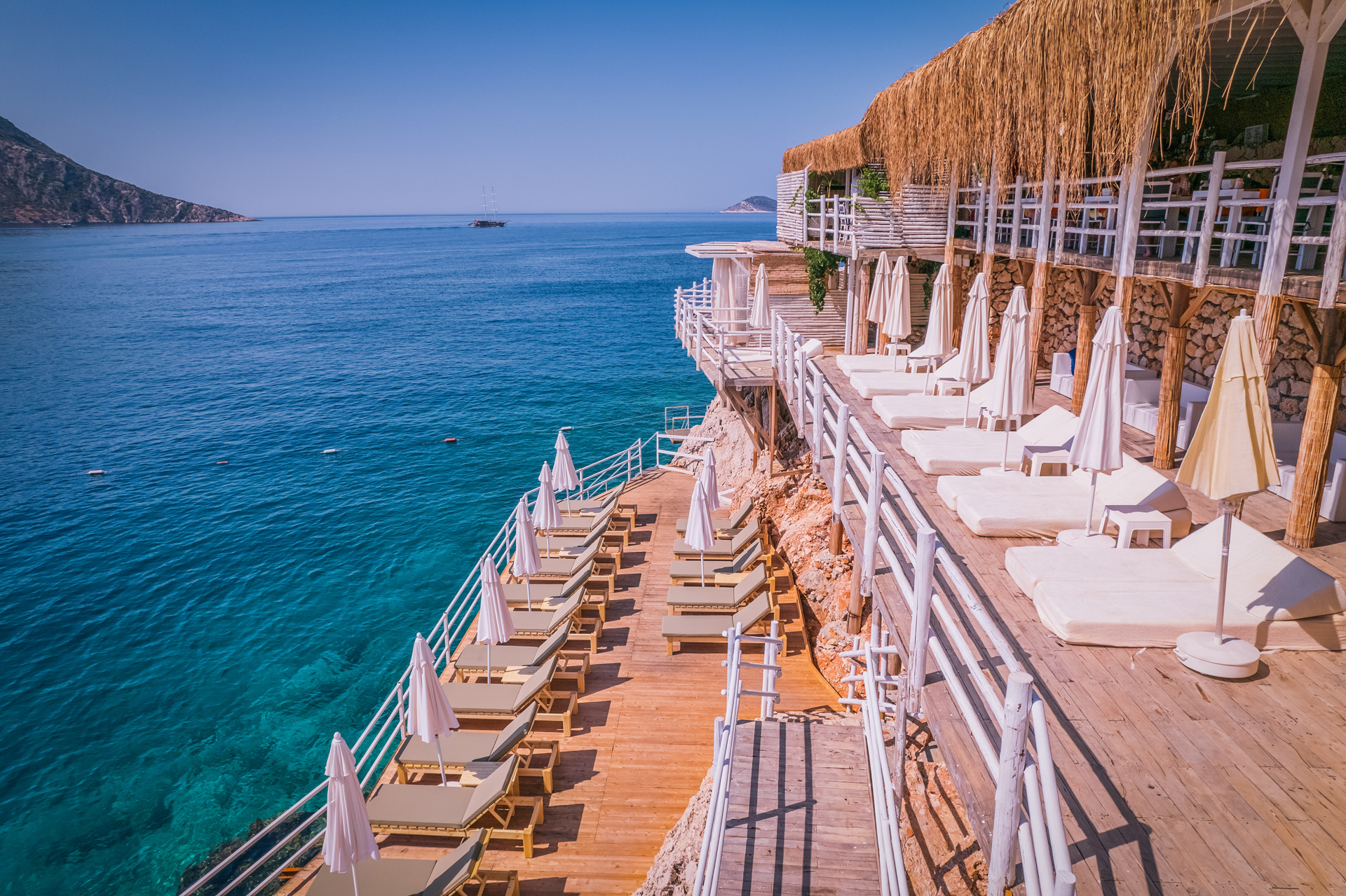 A terrace of sun loungers by the sea at Likya Pavilion in Kalkan, Turkey