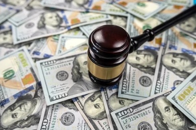Gavel on top of US dollar bills.
