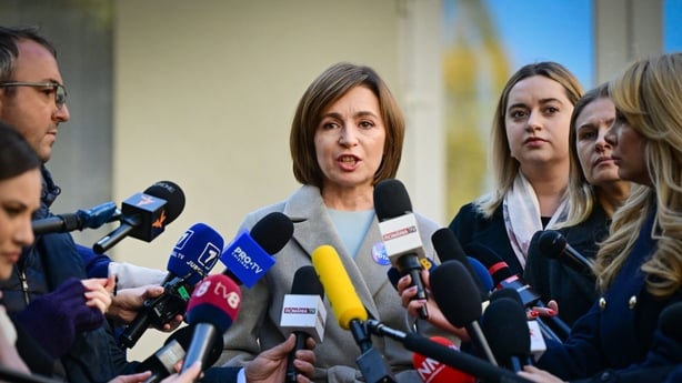 Current Moldova's President and candidate Maia Sandu (C) addresses media after she casted her vote for the presidential election at a polling station in Chisinau November 3, 2024. Moldova's pro-EU President Maia Sandu is facing Alexandr Stoianoglo, whom she fired as prosecutor general in 2023, in a 