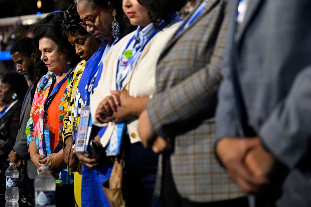 Delegates pray during first day of the Democratic National Convention in Chicago, Illinois, on August 19.