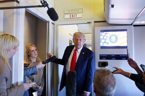 Donald Trump speaks to reporters on Air Force One