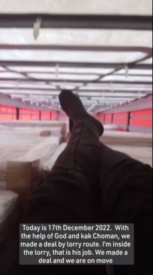 A migrant films himself travelling in the back of a lorry