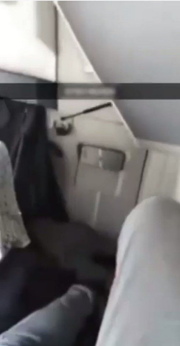 A migrant films himself travelling in the back of a lorry