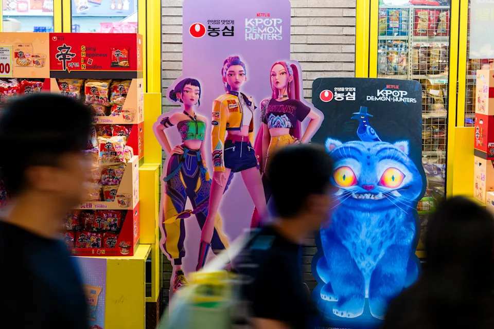 People walk by “KPop Demon Hunters”-themed instant noodles and snacks in the tourist district of Myeongdong in Seoul on Tuesday. - (Jintak Han/The Washington Post)