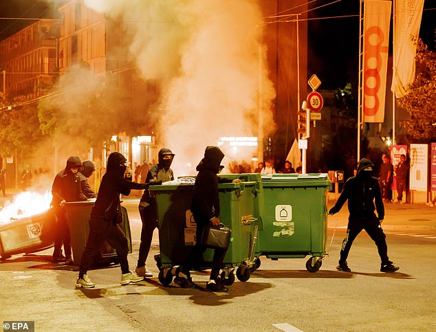Protesters burn containers during the second night of riots following the fatal accident involving a minor on a scooter in Lausanne, Switzerland, 25 August 2025