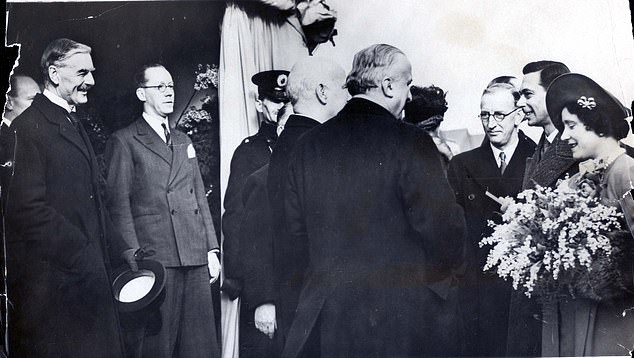 The king and queen leaving the Austin aircraft factory at Longbridge during a tour of Birmingham in 1939, accompanied by then prime minister Neville Chamberlain, left