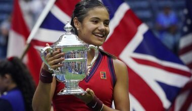 Emma Raducanu pictured in front of a Union Jack flag after winning the US Open in 2021