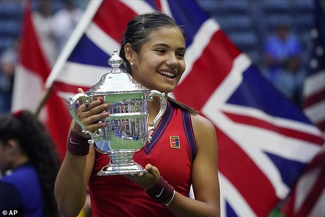 Emma Raducanu pictured in front of a Union Jack flag after winning the US Open in 2021