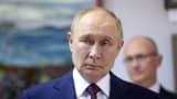 Russian President Vladimir Putin (L) observes an exhibition as Presidential Deputy Chief of Staff Sergey Kiriyenko (Kirienko) (R) looks on while visiting the All-Russian Scientific Research Institute Of Experimental Physics on August 22, 2025 in Sarov, Russia.