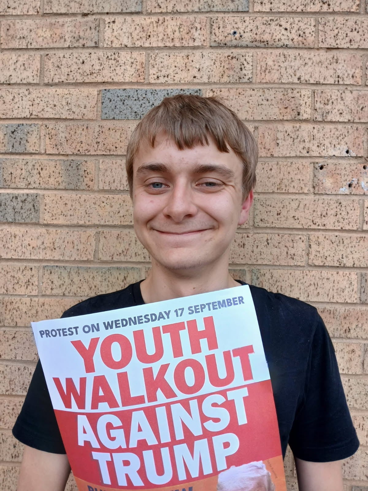 Adam Gillman holding a youth walkout sign
