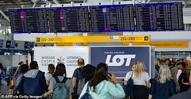 Passengers check their delayed flights on monitors at the international airport in Warsaw, on September 10, 2025, after the airport was closed due to Russian drones violated Polish airspace on Wednesday morning. NATO air defences helped counter drones that entered Polish airspace overnight and alliance chief Mark Rutte is in contact with Warsaw, a NATO spokeswoman said Wednesday. Polish Prime Minister Donald Tusk said Wednesday that a violation of Polish airspace by several Russian drones overnight was a major provocation aimed at the EU and NATO member. (Photo by Wojtek RADWANSKI / AFP) (Photo by WOJTEK RADWANSKI/AFP via Getty Images)