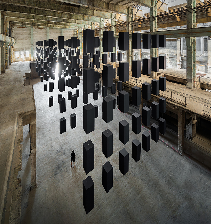 SpY's suspended grid installation of black rectangles floats within turbine factory in hungary