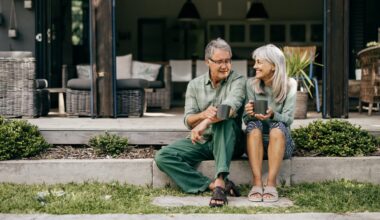 With coffee in hand, a senior couple in their 60s embraces a quiet moment, appreciating the beauty of their home.