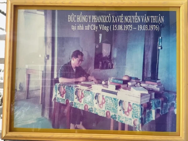 A photo of Van Thuan recently found in Vietnam shows the archbishop writing at a table when he was under house arrest in 1975. Credit: Photo courtesy of Elisabeth Nguyen