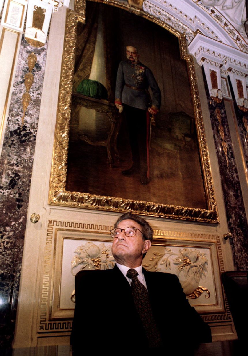 George Soros sits under a portrait of Austrian emperor Franz Joseph, in the House of Industry in Vienna, on April 26, 1995.