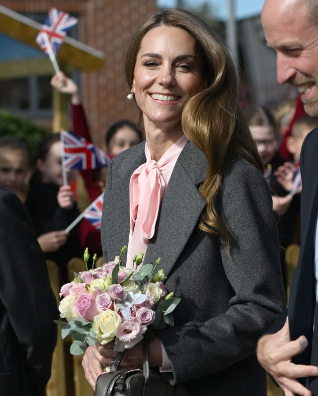 Princess of Wales smiling, while carrying a posy of flowers