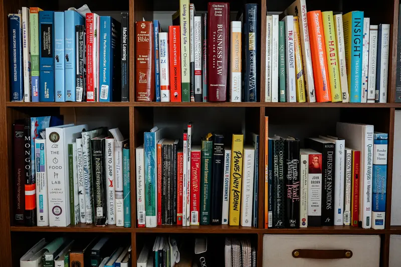 A shelf filled with a variety of books.