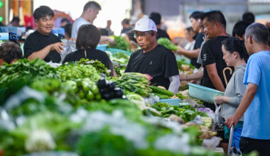 Customers purchase vegetables at an agricultural trade market in Nanjing, Jiangsu Province of China.