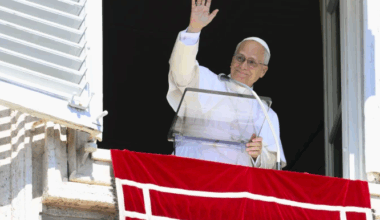 Pope Leo XIV waves to those gathered in St. Peter's Square to pray the Angelus and listen to his Sunday message on Sept. 21, 2025.
