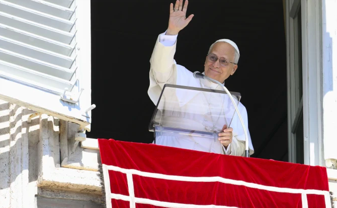 Pope Leo XIV waves to those gathered in St. Peter's Square to pray the Angelus and listen to his Sunday message on Sept. 21, 2025.