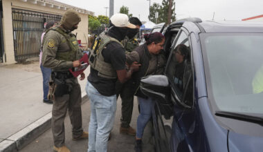 A woman is detained by U.S. Border Patrol agents outside a Home Depot Friday, Aug. 15, 2025, in ...
