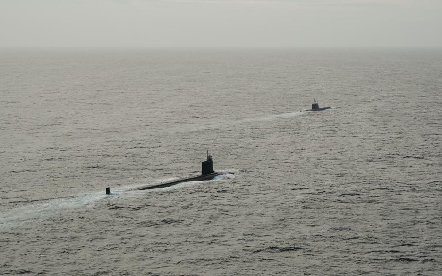 Two submarines sailing next to one another.