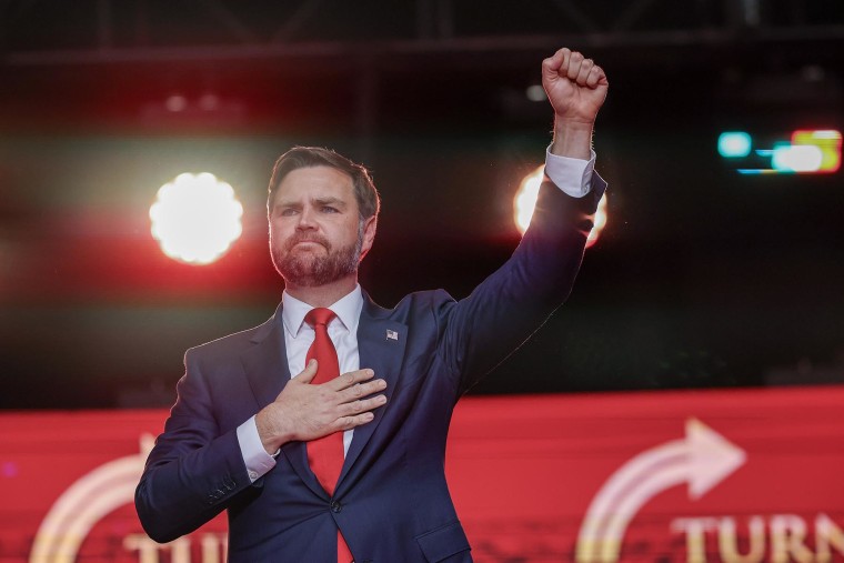 Vice President JD Vance gestures as he stands on stage during the memorial service for political activist Charlie Kirk at State Farm Stadium on September 21, 2025 in Glendale, Arizona.