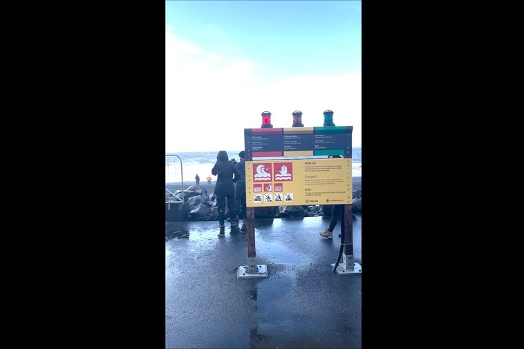 Tourists ignore red warning light at Reynisfjara Black Beach