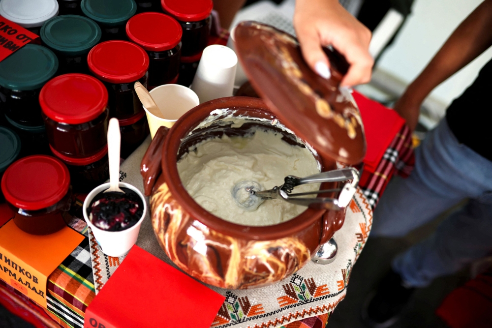 A local producer shows Bulgarian yogurt displayed during the Yogurt Festival in the village of Momchilovtsi, Bulgaria, August 30, 2025. — Reuters pic