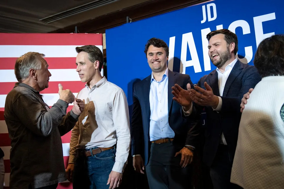 Charlie Kirk, middle right, and JD Vance, right, after a campaign rally in 2022 (Getty Images)