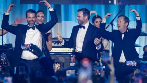 Getty Images WASHINGTON, DC - JANUARY 19: (L-R) Donald Trump Jr., Bettina Anderson, U.S. Vice President-elect JD Vance, and Sergio Gor dance on stage as The Village People perform YMCA during the Turning Point USA Inaugural-Eve Ball at the Salamander Hotel on January 19, 2025 in Washington, DC. Donald Trump will be sworn in as the 47th U.S. president on January 20. 