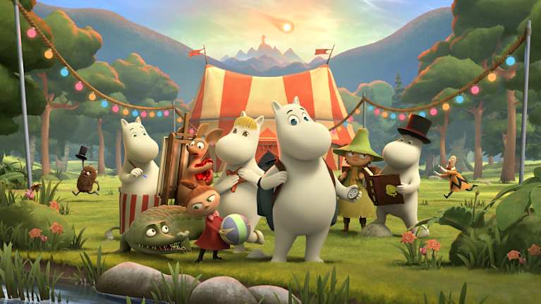 A group of Moomin characters standing in front of a circus tent.