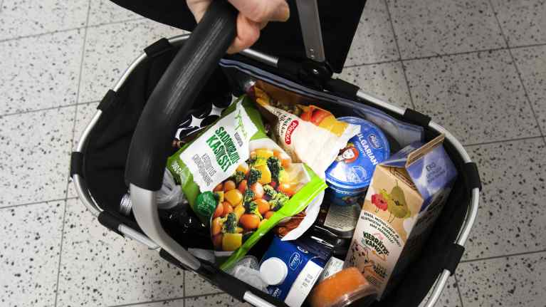 Photo shows a basket of groceries.