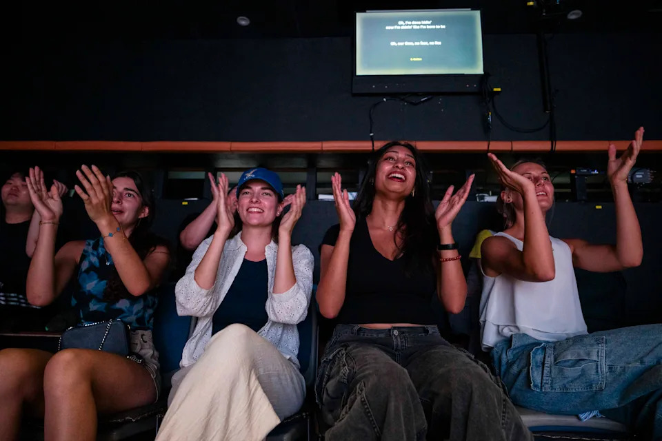 Exchange students from Switzerland, Germany, the United States and Austria cheer to “Golden” during the sing-along event. - (Jintak Han/The Washington Post)