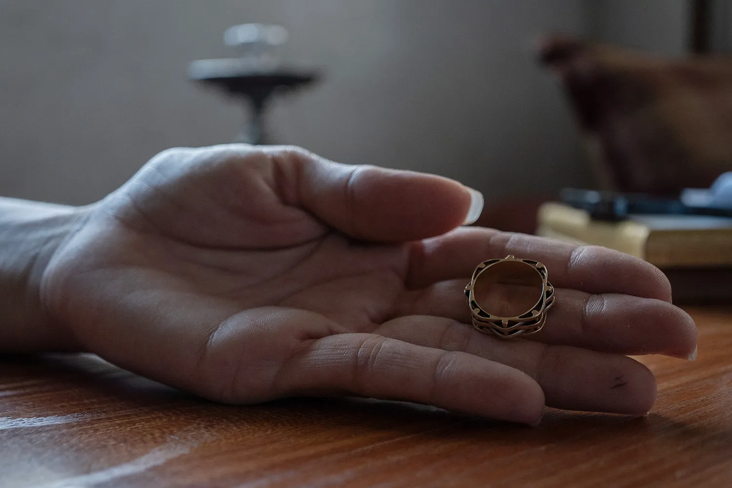 A hand displays wedding ring.