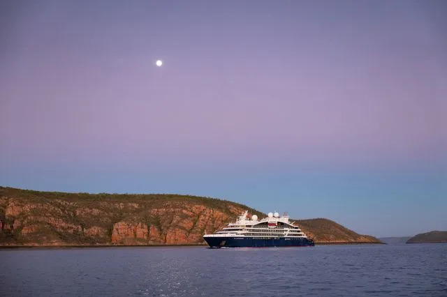 Nick Rains/Ponant The Le Lapérouse ship by Ponant at sea under the moon.