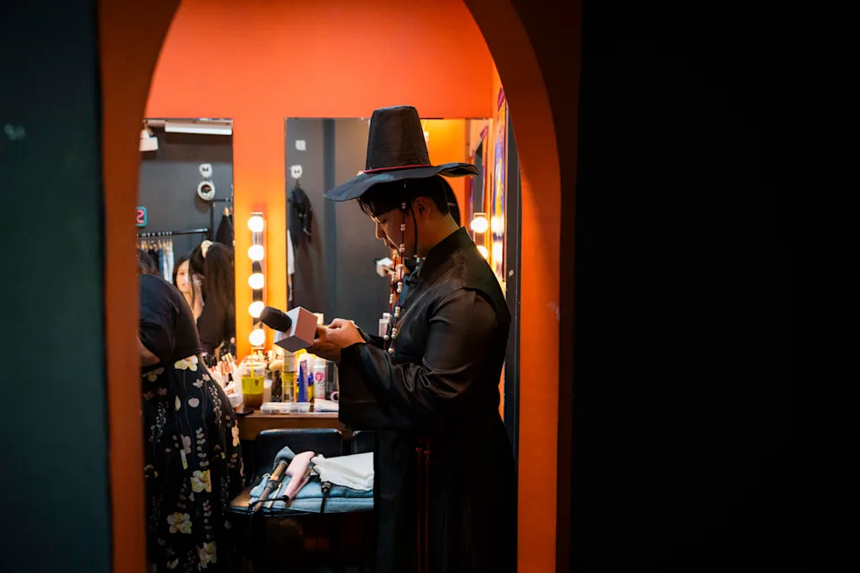 An emcee dressed as a member of the Saja Boys, a boy band from the movie, prepares to host the sing-along event on Thursday. - (Jintak Han/The Washington Post)