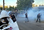 Department of Homeland Security officers deploy crowd control munitions, including tear gas, at a demonstration outside the ICE building on June 14, 2025.