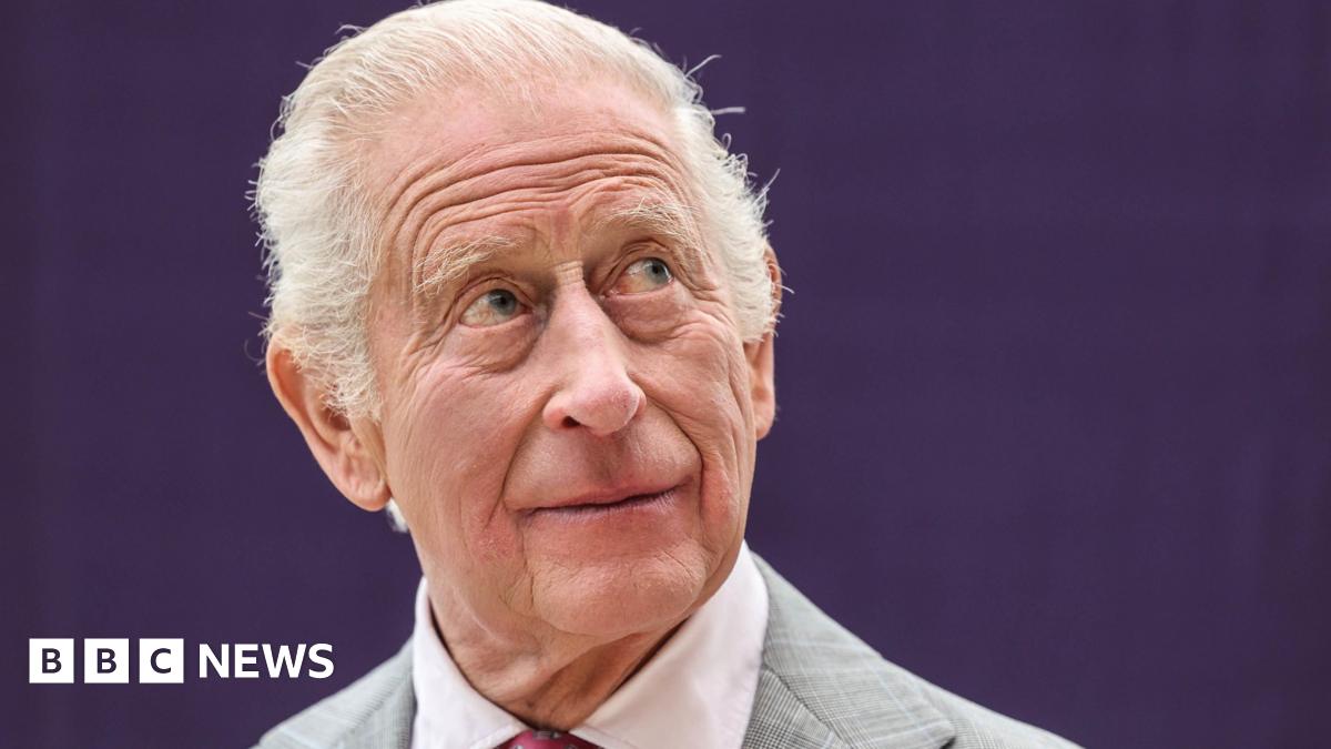 King Charles III during his visit to officially open the new Midland Metropolitan University Hospital in Birmingham. He has short grey hair and is wearing a grey suit.