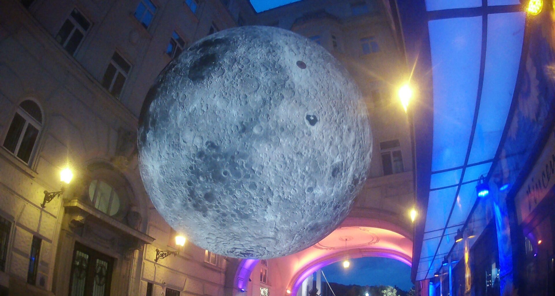 Budapest, Hungary - Inflatable mini-Moon suspended in a small street