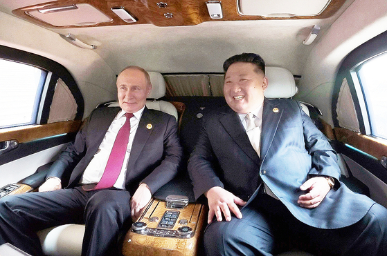 North Korean leader Kim Jong-un, right, and Russian President Vladimir Putin ride together in a vehicle in this photo released by the state-run Rodong Sinmun on Sept 4. [RODONG SINMUN]