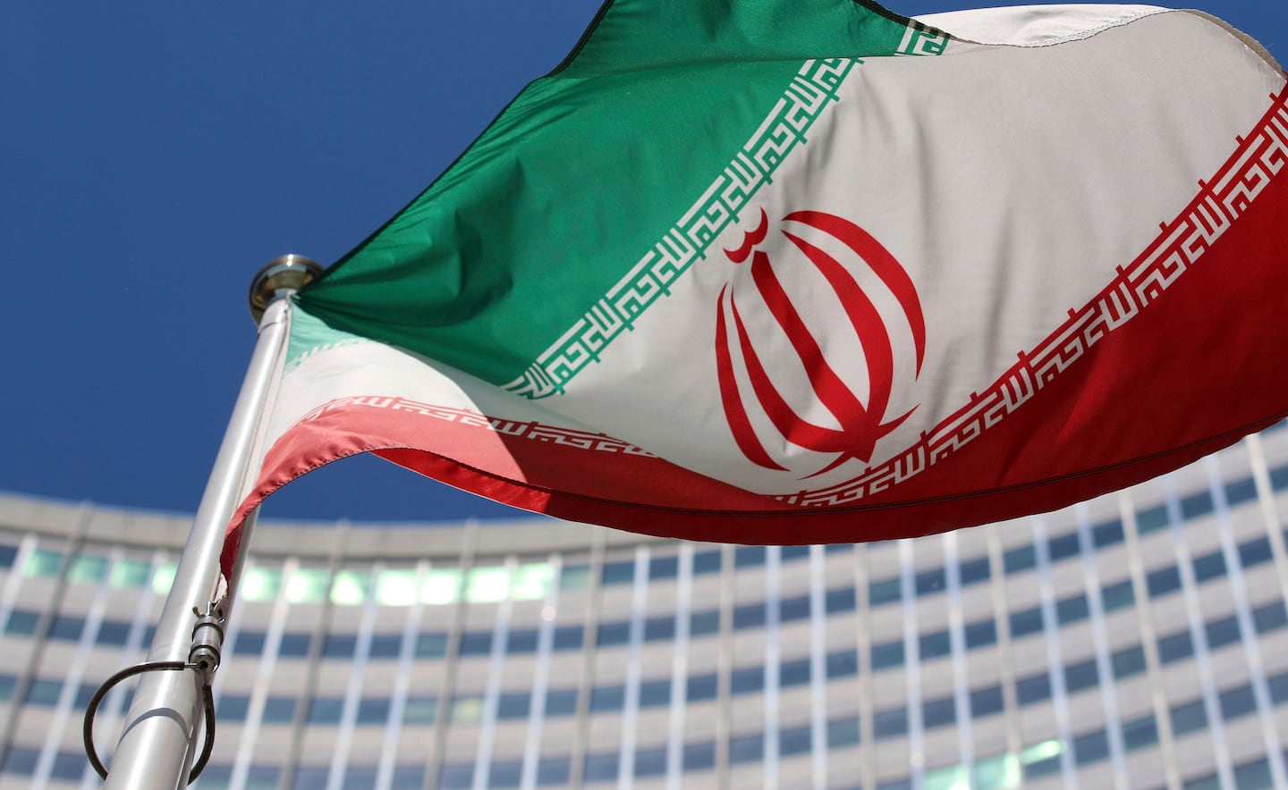 The Iranian flag flies in front of a U.N. building in Vienna, Austria.