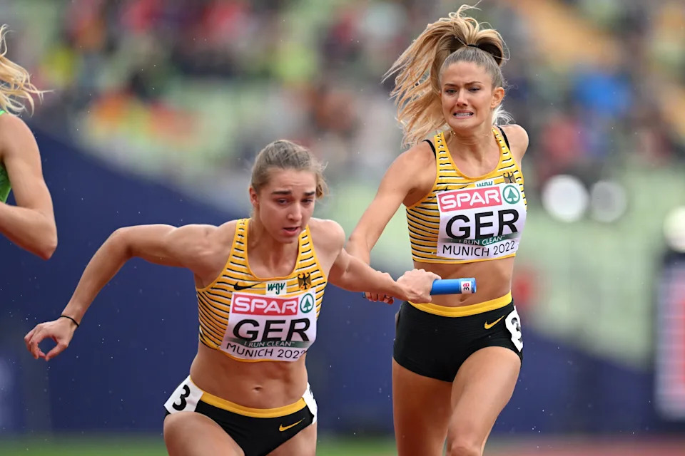 MUNICH, GERMANY - AUGUST 19: Alica Schmidt and Mona Mayer of Germany compete in the Women's 4 x 400m Relay Round 1 - Heat 2 during the Athletics competition on day 9 of the European Championships Munich 2022 at Olympiapark on August 19, 2022 in Munich, Germany. (Photo by Matthias Hangst/Getty Images)