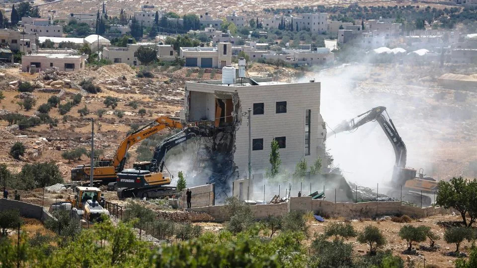 Israeli bulldozers demolish a Palestinian house in the village of Marah Ma'ala, south of Bethlehem in the occupied West Bank, July 13, 2025. - Mosab Shawer/Middle East Images/AFP/Getty Images