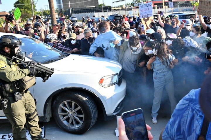 ICE officers clash with demonstrators outside an Immigration and Customs Enforcement (ICE) facility using smoke gas and plastic bullets to disperse crowds protesting against deportations in Broadview, Illinois, on Friday.
