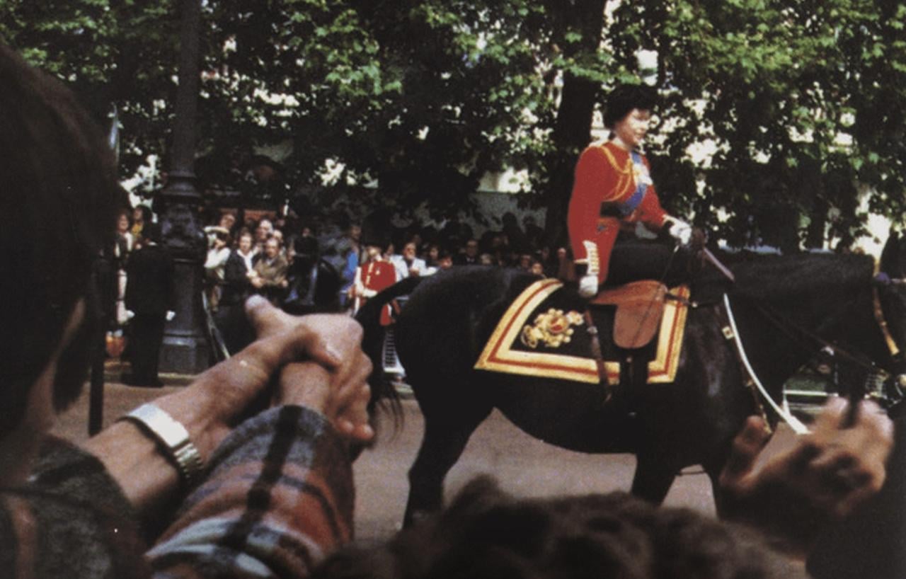 Queen Elizabeth II at the moment when Marcus Sarjeant is preparing to fire six blank shots in her direction. United Kingdom, 1981.