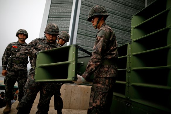 South Korean soldiers pictured in 2018 with loudspeakers used to broadcast propaganda and K-pop into North Korea near the border village of Paju. In August, South Korea began dismantling its speakers in a bid to ease tensions. 